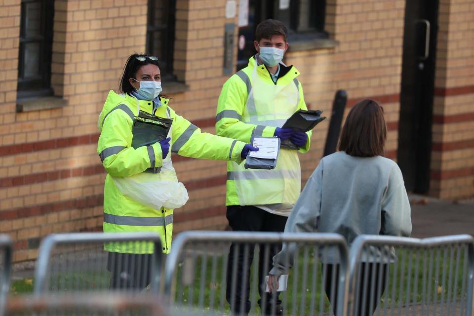 NHS staff hand out test kits to Glasgow University students (PA)