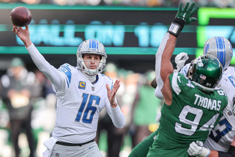 Detroit Lions quarterback Jared Goff throws as New York Jets defensive end Solomon Thomas defends during the first half at MetLife Stadium Dec. 18, 2022 in East Rutherford, New Jersey.