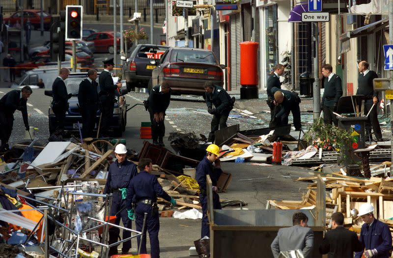 FILE PHOTO: Security forces examine the scene of the Omagh bombing in Northern Ireland