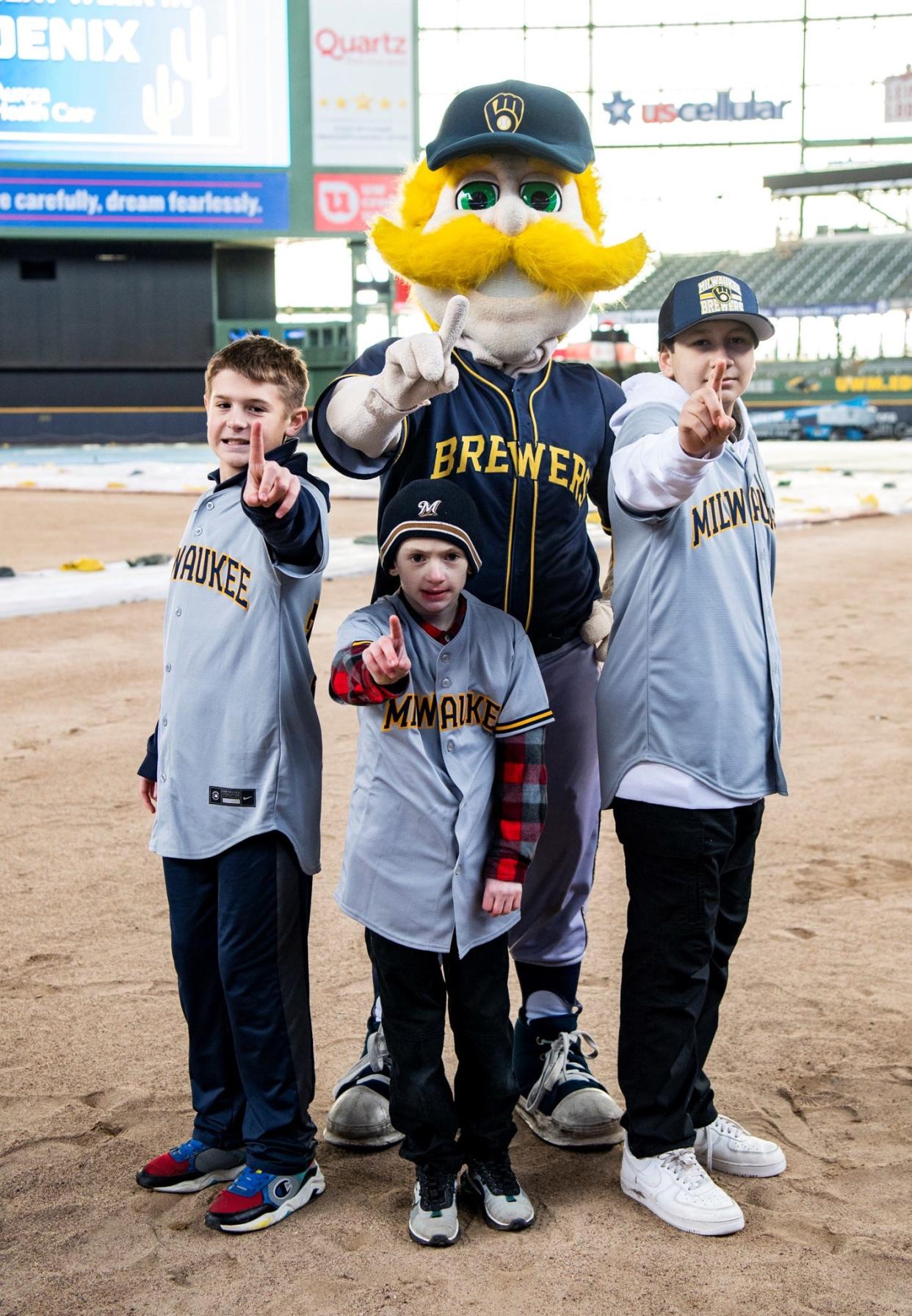 Bernie Brewer, the Milwaukee Brewers' mascot, joins (from left) 13-year-old Nolen Rosenthal of Lannon, 9-year-old Owen Strege of Algoma and 13-year-old Dazian Garcia of Greenfield after the youths and their families learned Feb. 18 at American Family Field in Milwaukee that they were invited by the Brewers and Aurora Health Care to visit the team's Spring Training camp in Phoenix and throw out the first pitch of the opening spring game Feb. 25.