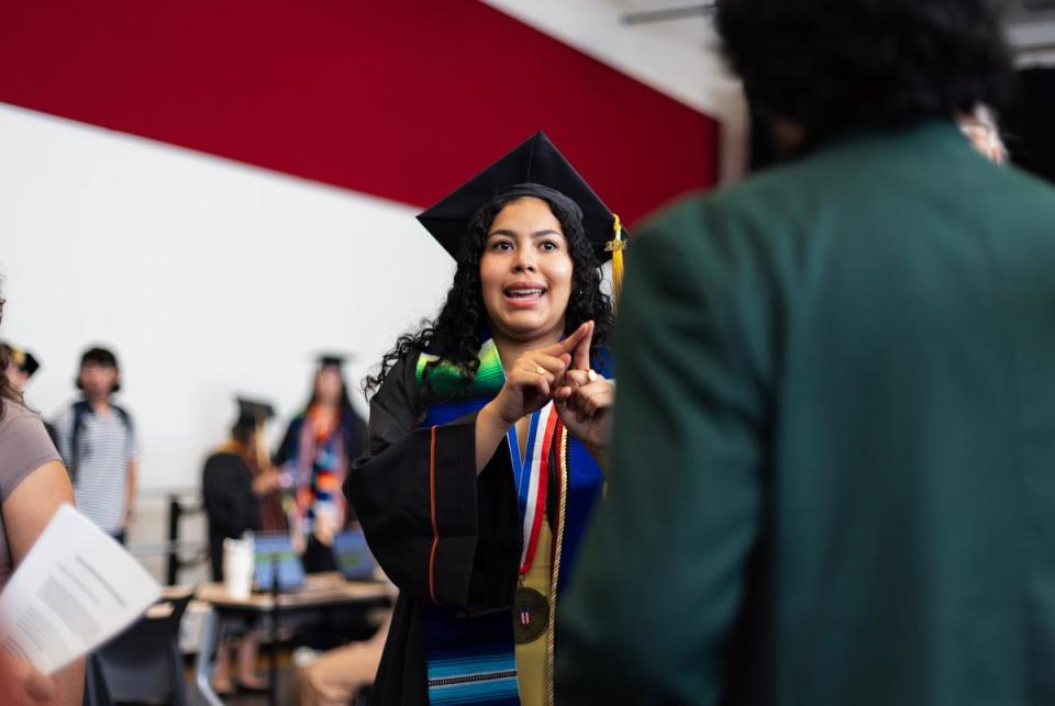 Liany Serrano Oviedo assigns roles to organizers prior to the University of Texas at Austin Latinx Graduation on Thursday, May 9, 2024 in Austin. Oviedo was helping to provide instructions on how to guide graduates into the ceremony and organize everyone during the ceremony.
