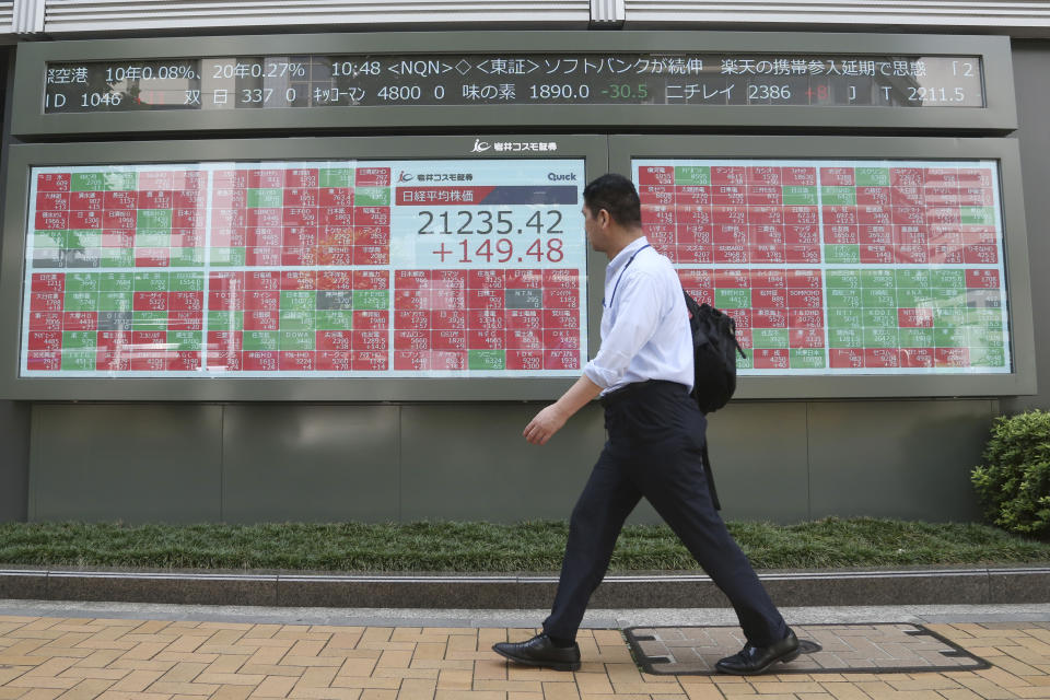 A man walks by an electronic stock board of a securities firm in Tokyo, Friday, Sept. 6, 2019. Asian shares rose Friday as investors cheered plans for more trade negotiations between Washington and Beijing and drew encouragement from positive data about the U.S. economy. (AP Photo/Koji Sasahara)