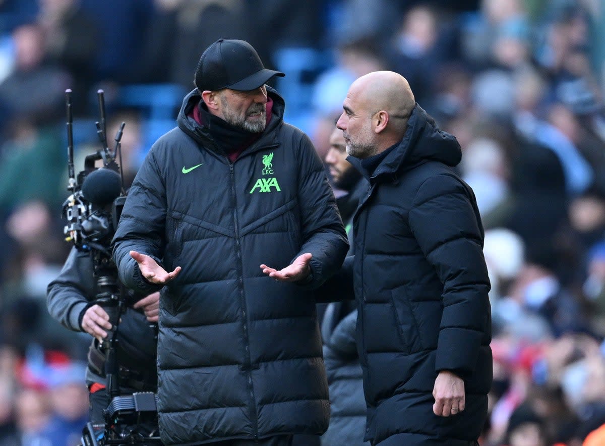 Klopp and Guardiola exchange thoughts on the touchline (Getty)