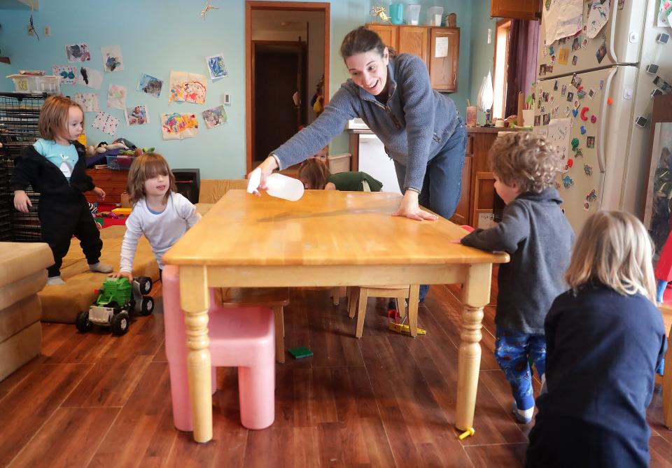 Corrine Hendrickson cleans a snack table on Jan. 25 at her home-based family child care center, Corrine's Little Explorers in New Glarus.