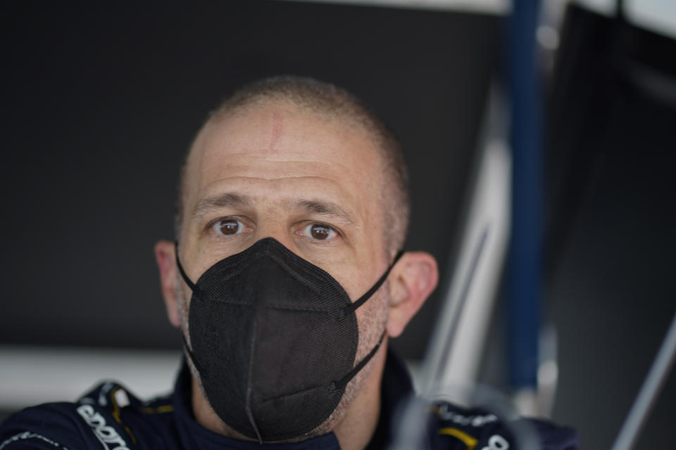 Tony Kanaan, of Brazil, watches from his pit box during practice for the Indianapolis 500 auto race at Indianapolis Motor Speedway, Wednesday, May 19, 2021, in Indianapolis. (AP Photo/Darron Cummings)