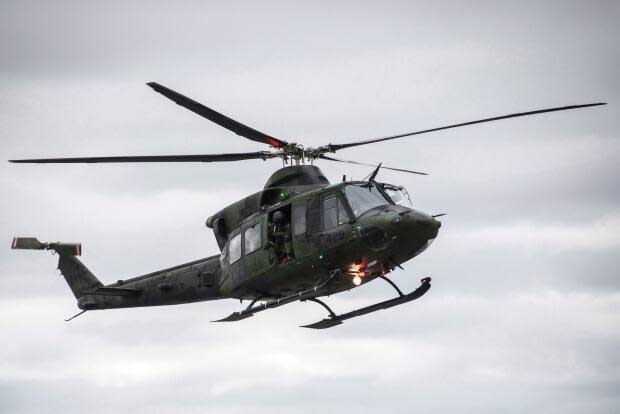 A CH-146 Griffon helicopter is shown at Billy Bishop Toronto City Airport in 2016. Helicopters from the Royal Canadian Air Force in CFB Gagetown will be flying over Saint John and Fredericton on Sunday.  (Christopher Katsarov/Canadian Press - image credit)