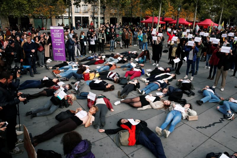 People stage a "die-in" at Place de la Republique during a demonstration against femicide and violence against women in Paris