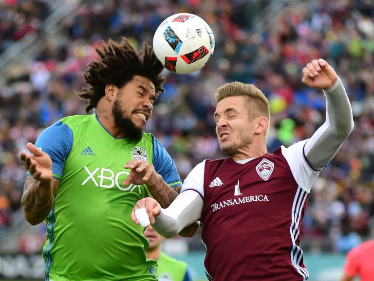 Roman Torres of Seattle Sounders and Kevin Doyle of Colorado Rapids jump for a header during the first half at Dick's Sporting Goods Park on November 27, 2016