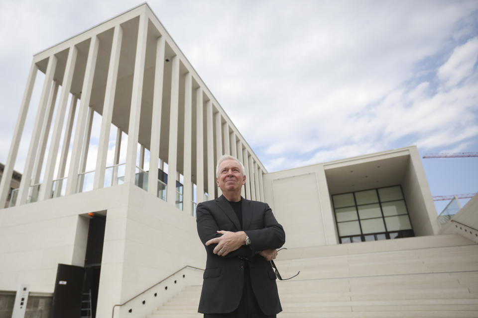 In this Monday, July 1, 2019 photo, architect David Chipperfield poses outside of the James-Simon-Galerie at the Museumsinsel, Museums Island, in Berlin, Germany. The building, designed by David Chipperfield, is the new central entrance building for the museums at the Museumsinsel of the German capital. (AP Photo/Markus Schreiber)
