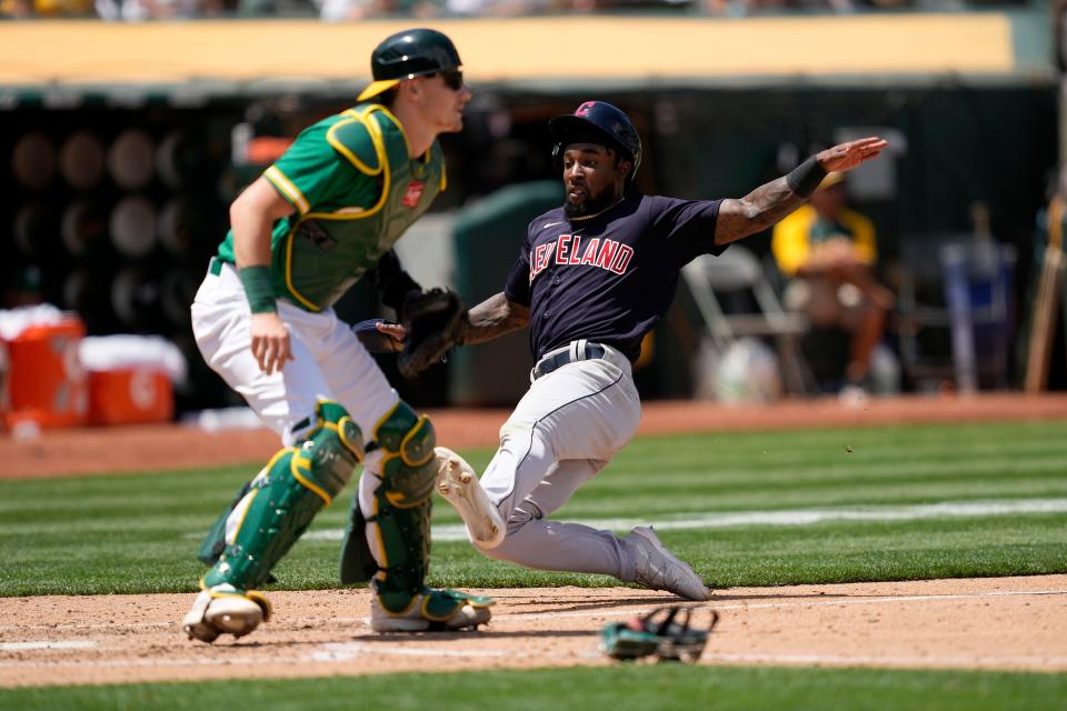 Cleveland's Daniel Johnson, right, slides into home plate past Oakland Athletics catcher Sean Murphy, left, to score a run on a single by Bradley Zimmer during the fifth inning of a baseball game Sunday, July 18, 2021, in Oakland, Calif. (AP Photo/Tony Avelar)