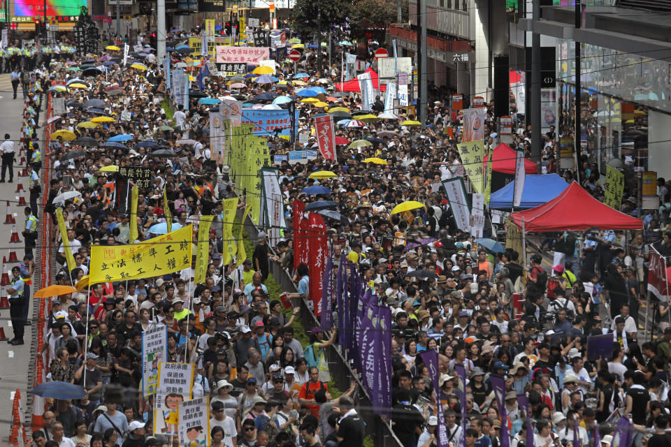 In this July 1, 2018, file photo, thousands of protesters march along a downtown street during an annual pro-democracy protest in Hong Kong. A national security law enacted in 2020 and COVID-19 restrictions have stifled major protests in Hong Kong including an annual march on July 1. (AP Photo/Vincent Yu, File)
