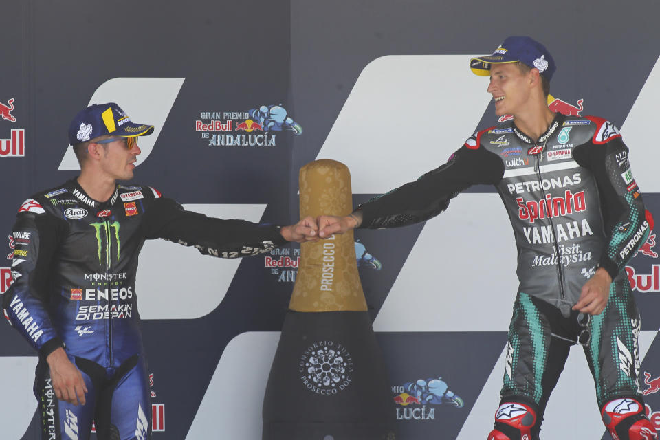 MotoGP race winner Fabio Quartararo of France, right, touches fists with 2nd placed Maverick Vinales of Spain during the MotoGP race during the Andalucia Motorcycle Grand Prix at the Angel Nieto racetrack in Jerez de la Frontera, Spain, Sunday July 26, 2020. (AP Photo/David Clares)