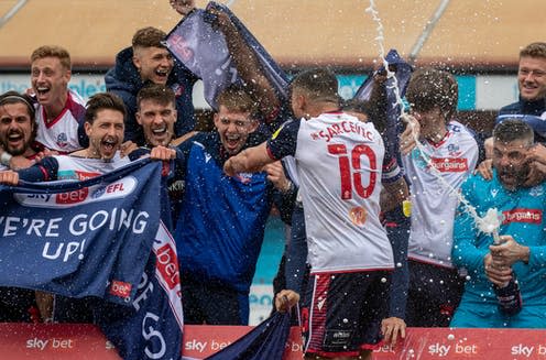 <span class="caption">Bolton Wanderers celebrating promotion to League One in 2021.</span> <span class="attribution"><a class="link " href="https://www.shutterstock.com/image-photo/crawley-united-kingdom-0801-town-14-1971351377" rel="nofollow noopener" target="_blank" data-ylk="slk:Shuttterstock/Jake Kirkman;elm:context_link;itc:0;sec:content-canvas">Shuttterstock/Jake Kirkman</a></span>