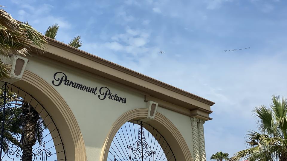 Plane flies over Paramount Pictures with the banner that reads “Pay the writers, you AI-holes!”