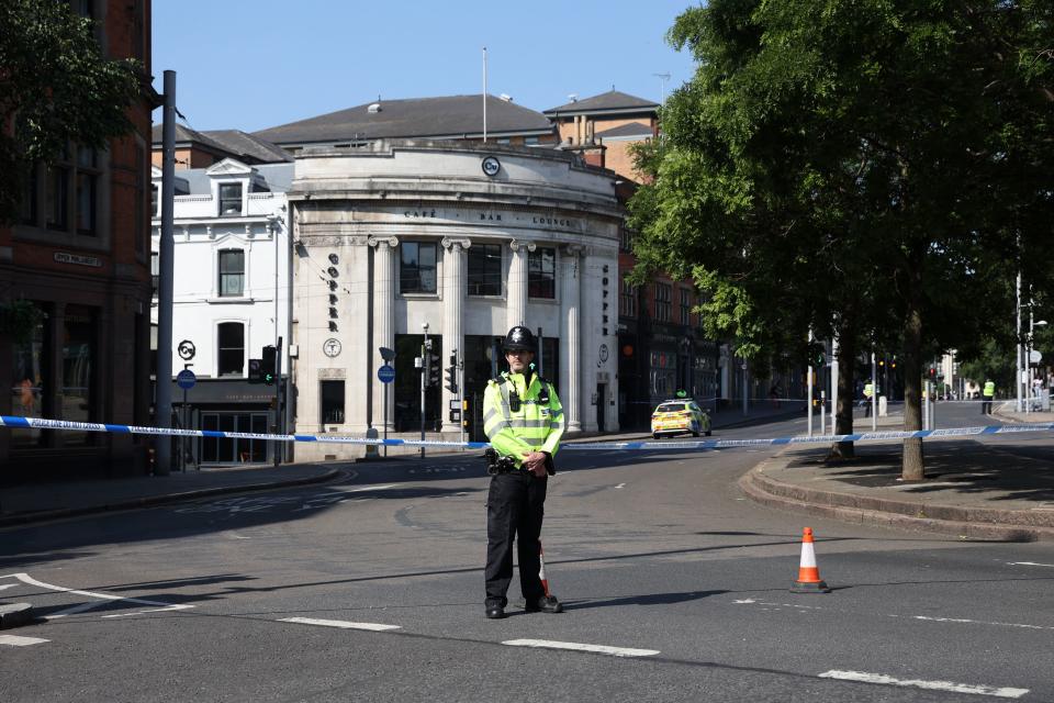 A police officer stands by a cordon on Upper Parliament Street in Nottingham, central England, during a 'major incident' in which three people have been found dead. UK police on Tuesday locked down the central English city of Nottingham after three people were found dead in a 