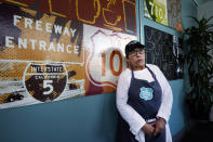 The Porter Junction Cafe owner Anette Lopez comments on how the closure of Interstate 10 has affected her cafe, decorated with interstate signs in Los Angeles, Tuesday, Nov. 14, 2023. California Gov. Gavin Newsom says a stretch of I-10 in Los Angeles that was burned in an act of arson does not need to be demolished, and that repairs will take an estimated three to five weeks. (AP Photo/Damian Dovarganes)