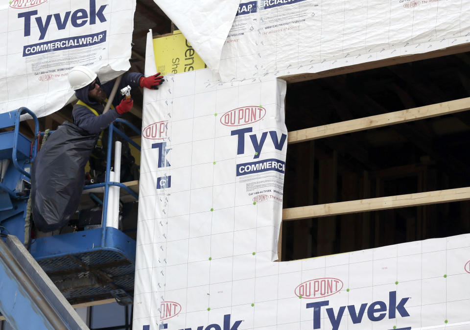 In this March 26, 2014 photo, a builder works on a home under construction in northwest Chicago. The Conference Board reports on its index of leading economic indicators for March on Monday, April 21, 2014. (AP Photo/Nam Y. Huh)