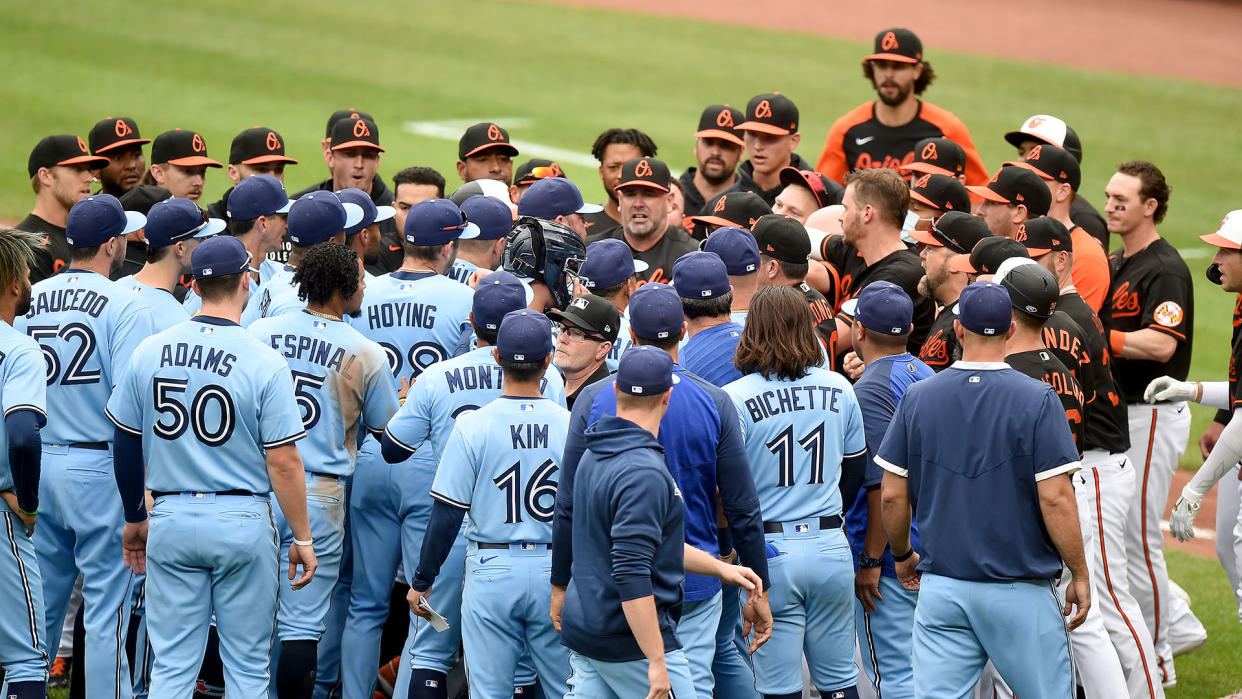 The Baltimore Orioles and Toronto Blue Jays dugouts empty onto the field after Maikel Franco #3 of the Baltimore Orioles was hit by a pitch. (Photo by Greg Fiume/Getty Images)