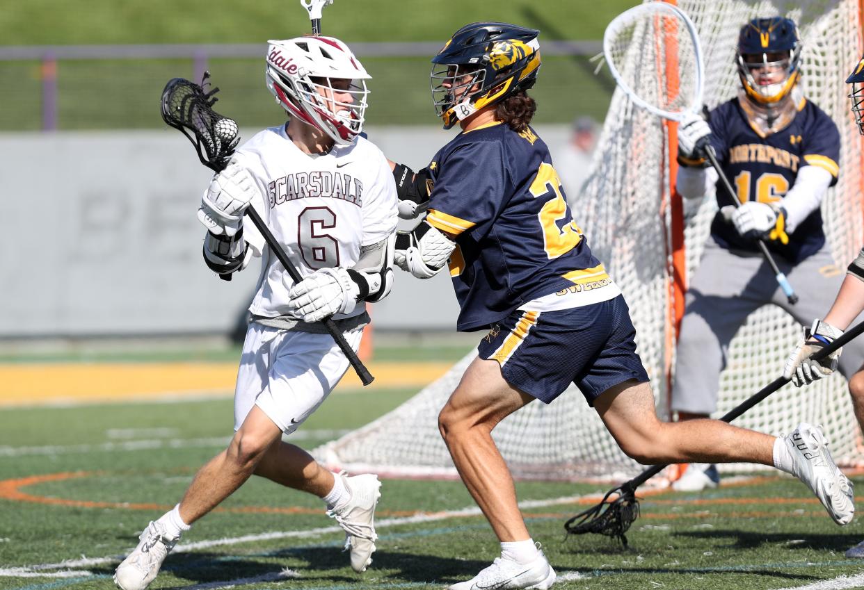 Scarsdale's Jake Goldstein (6) tries to get around Northport's Patrick Sweeney (23) during the boys lacrosse Class A semifinal at University of Albany June 8, 2022.  Northport won the game.