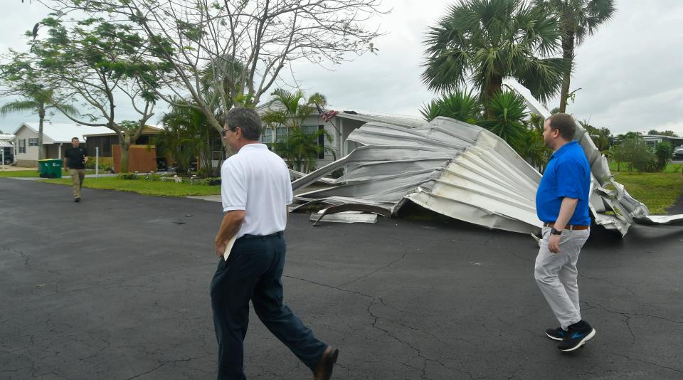 National Weather Service personnel inspect wind damages from an EF0 tornado in the River Grove Mobile Home Village in Micco.