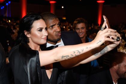 BEVERLY HILLS, CALIFORNIA - APRIL 02:  Honoree Demi Lovato (L) and NFL player Michael Sam take a selfie during the 27th Annual GLAAD Media Awards at the Beverly Hilton Hotel on April 2, 2016 in Beverly Hills, California.  (Photo by Frazer Harrison/Getty Images for GLAAD)