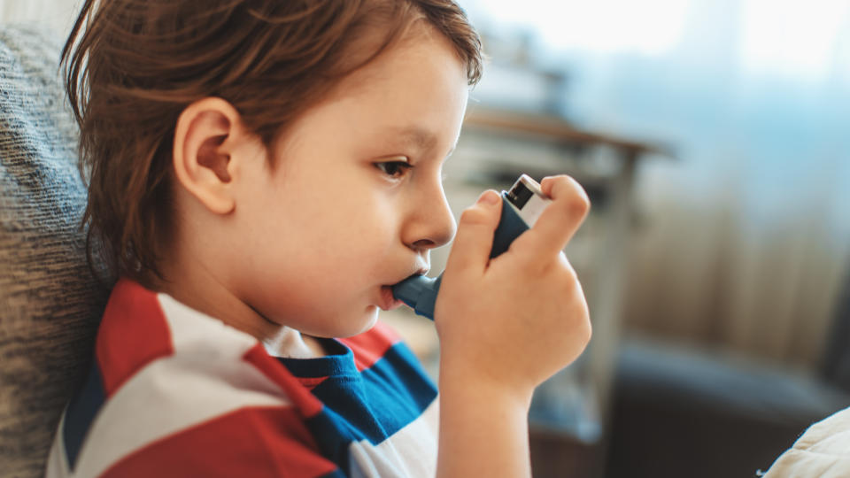 A file picture of a boy using an asthma puffer.