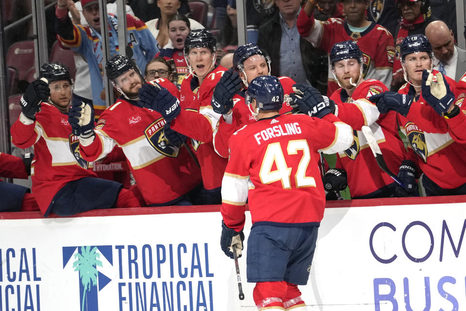 Florida Panthers defenseman Gustav Forsling (42) is congratulated after scoring a goal during the second period of an NHL hockey game against the Philadelphia Flyers, Thursday, March 7, 2024, in Sunrise, Fla. (AP Photo/Lynne Sladky)