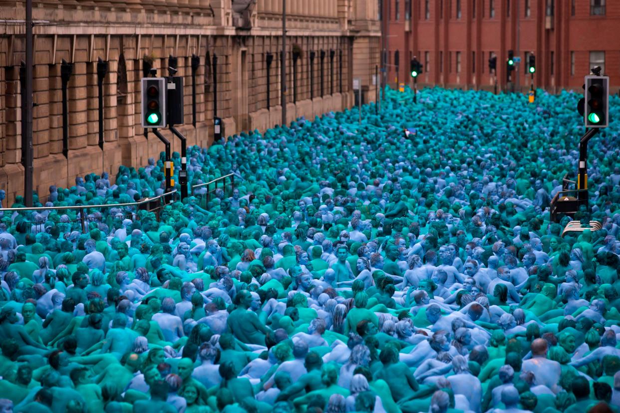 Naked volunteers, painted in blue to reflect the colors found in Marine paintings in Hull's Ferens Art Gallery, participate in US artist, Spencer Tunick's "Sea of Hull" installation in Kingston upon Hull on July 9, 2016.