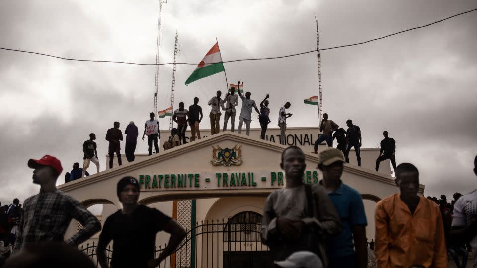 Protesters hold a Niger flag during a demonstration on independence day in Niamey on Thursday. - AFP via Getty Images