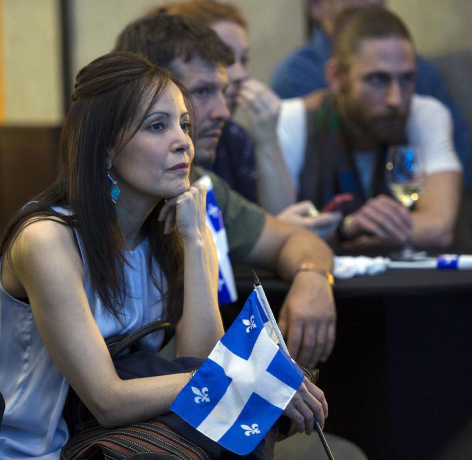 Parti Quebecois supporters listen to election results at the party's election headquarters Monday, April 7, 2014 in Montreal. (AP Photo/The Canadian Press, Paul Chiasson)