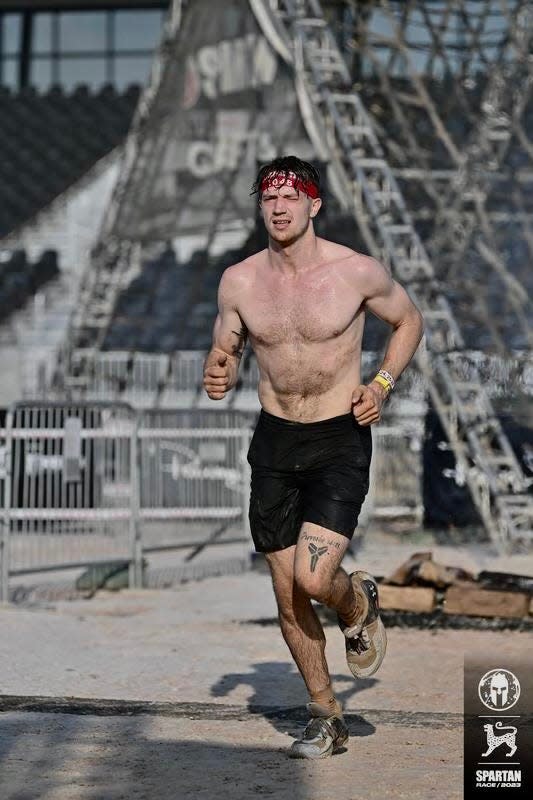 Ohio State men's basketball player Colby Baumann competes in a Spartan Race.