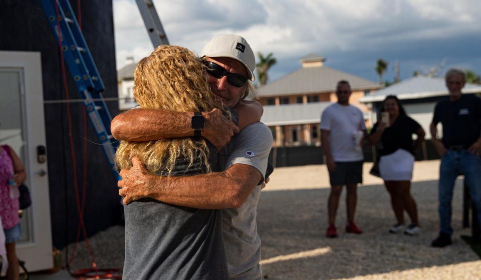 Rick Loughrey, a Fort Myers Beach resident and Hurricane Ian survivor, hugs his wife Amy after ending his protest Monday, August 7, 2023. Loughrey spent six days on the roof of his garage hoping to get answers regarding the fate of his garage with recent interpretations of FEMA regulations by the Town of Fort Myers Beach. The protest ended without answers.