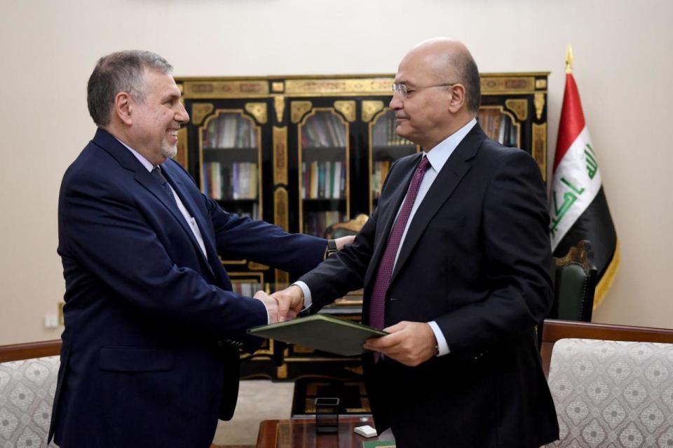 Iraqi President Barham Salih, right, instructs newly appointed Prime Minister Mohammed Allawi in Baghdad, Iraq, Saturday, Feb. 1, 2020. Former communications minister Mohammed Allawi was named prime minister-designate by rival Iraqi factions Saturday after weeks of political deadlock. (Iraqi Presidency Media Office, via AP)