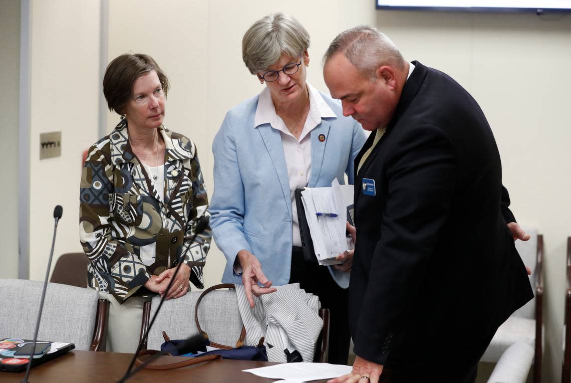 North Carolina Conference of DAs lobbyist Chuck Spahos, right, talks with Rep. Marcia Morey, center, and Rep. Rachel Hunt, left, before a meeting of the House Judiciary Committee in 2021. Prosecutors have gained more sway with the N.C. General Assembly since Spahos began lobbying for the group two and half years ago, observers say.