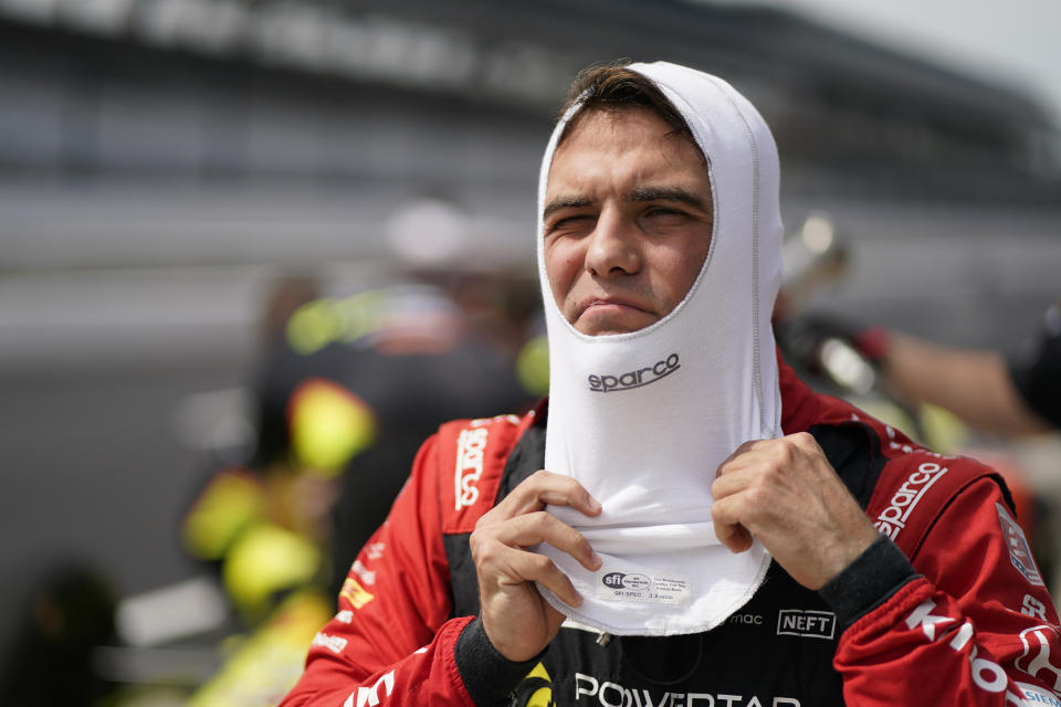 Delvin Defrancesco, of Canada, puts on his balaclava during practice for the Indianapolis 500 auto race at Indianapolis Motor Speedway, Thursday, May 19, 2022, in Indianapolis. (AP Photo/Darron Cummings)