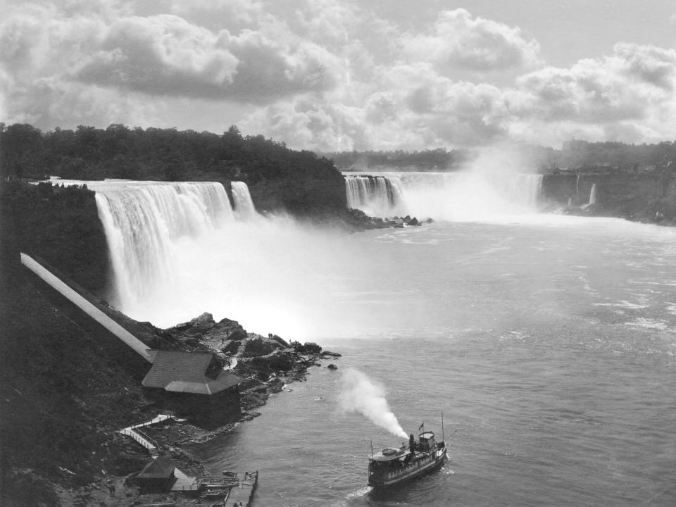 The American Falls and the Bridal Veil Falls are at the left with Horseshoe Falls at the right in 1890. A steamboat is seen in the water below the falls.