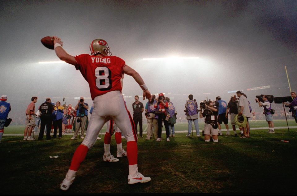 San Francisco 49ers quarterback Steve Young warms up following the smokey halftime extravaganza of their game against the San Diego Chargers in Super Bowl XXIX on Sunday, Jan. 29, 1995, at Joe Robbie Stadium in Miami. | Ed Reinke, Associated Press