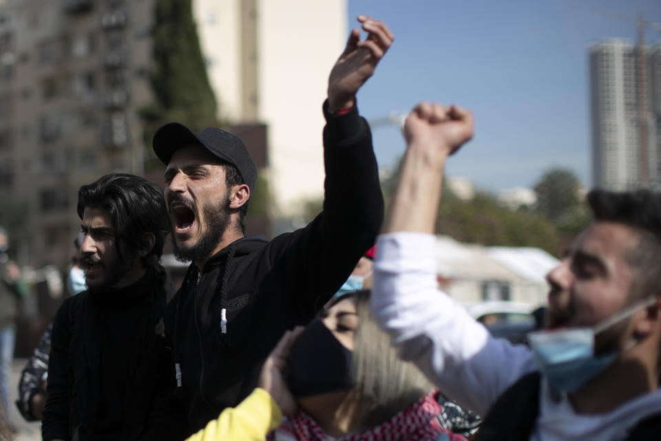 Anti-government protesters shout slogans outside a military court, in Beirut, Lebanon, Monday, Feb. 8, 2021. Riot police briefly clashed Monday in Beirut with hundreds of protesters demanding the release of anti-government activists detained following riots in northern Lebanon late last month. (AP Photo/Hassan Ammar)