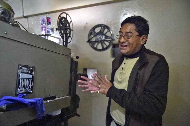 Hollywood cinema's projectionist Patricio Veloz, shown in his projection room in Quito, on March 6, 2015, saw his first erotic film before finishing high school and landed a job at the ticket window, eventually working his way to the projection booth