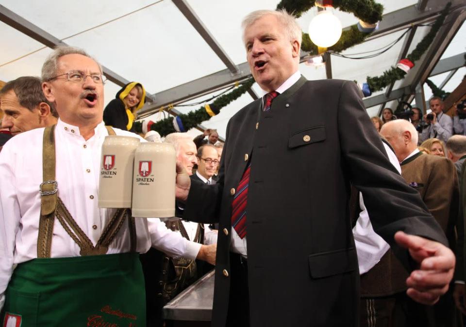 Munich mayor Christian Ude (L) and Bavarian state premier Horst Seehofer toast with the first barrels of beer to start the Oktoberfest 2012 beer festival.