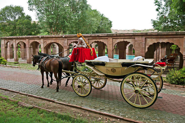 A horse drawn carriage at Bal Samand Lake Palace. Grooms can arrive at the wedding in their choice of vintage car or royal horse-drawn carriage. The palace staff will organise everything from customised menus and stay for your guests to travel arrangements you may need. If your guests are in the mood to experience Rajasthani culture, they will even arrange entertainment in the form of high teas, polo matches or sand dune safaris.