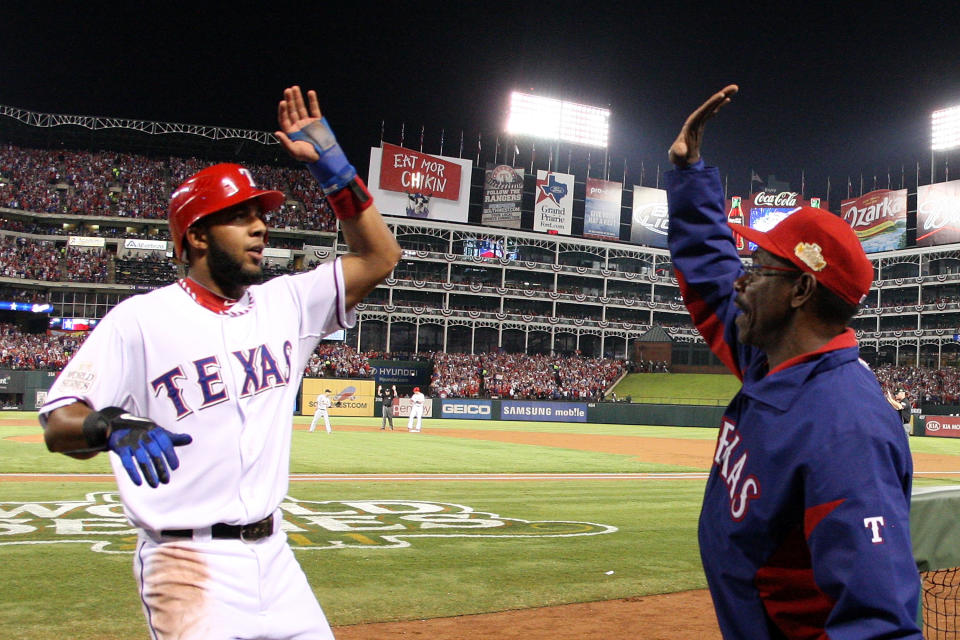 ARLINGTON, TX - OCTOBER 23: Elvis Andrus #1 of the Texas Rangers celebrates with manager Ron Washington after scoring in the first inning during Game Four of the MLB World Series against the St. Louis Cardinals at Rangers Ballpark in Arlington on October 23, 2011 in Arlington, Texas. (Photo by Tom Pennington/Getty Images)