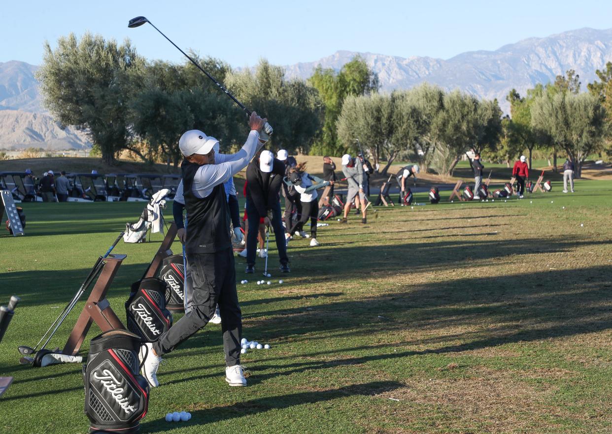 Golfers warm up on the driving range before the Clubs for Kids Golf Tournament at Classic Club in Palm Desert, Calif., Dec. 13, 2023.