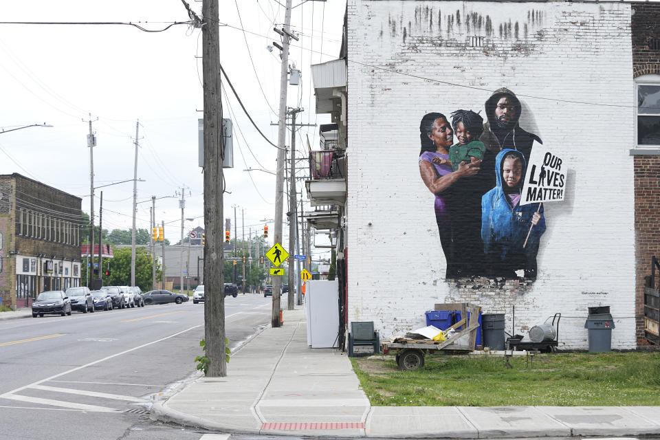 A mural is pictured on a near-empty street near MAC Pharmacy, Wednesday, May 29, 2024, in Cleveland. An Associated Press analysis of licensing data from 44 states, data from the National Council of Prescription Drug Programs and the American Community Survey shows residents of neighborhoods that are majority Black and Hispanic have fewer pharmacies per capita than people who live in mostly white neighborhoods. (AP Photo/Sue Ogrocki)