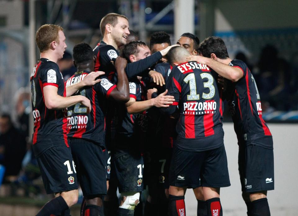 Nice's players celebrate after Nice's French midfielder Valentin Eysseric, second right, scored against Marseille, during their League One soccer match, at the Velodrome Stadium, in Marseille, southern France, Friday, March 7, 2014. (AP Photo/Claude Paris)