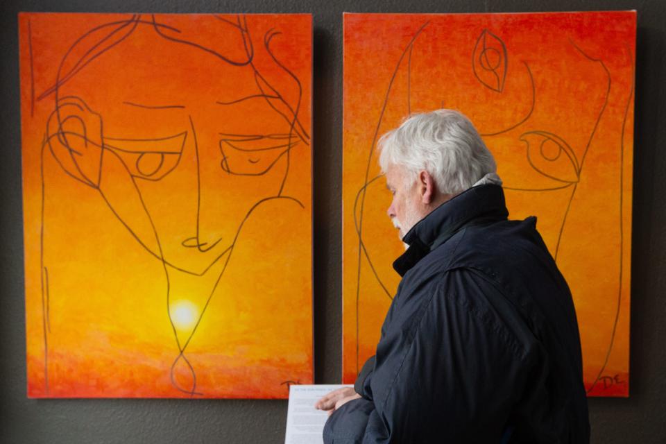 Stephen Smith stands by Denise Evans' paintings "As The Sun Rises" and "As The Sun Sets" in the front of his gallery at 931 S. Kansas Ave. on Jan. 9. Evans created the paintings over months of treatment while she was suffering from neurological diseases and daily seizures.