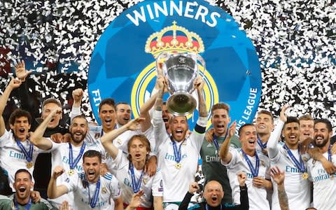 Real Madrid's Sergio Ramos lifts the trophy as they celebrate winning the Champions League  - Credit: Reuters