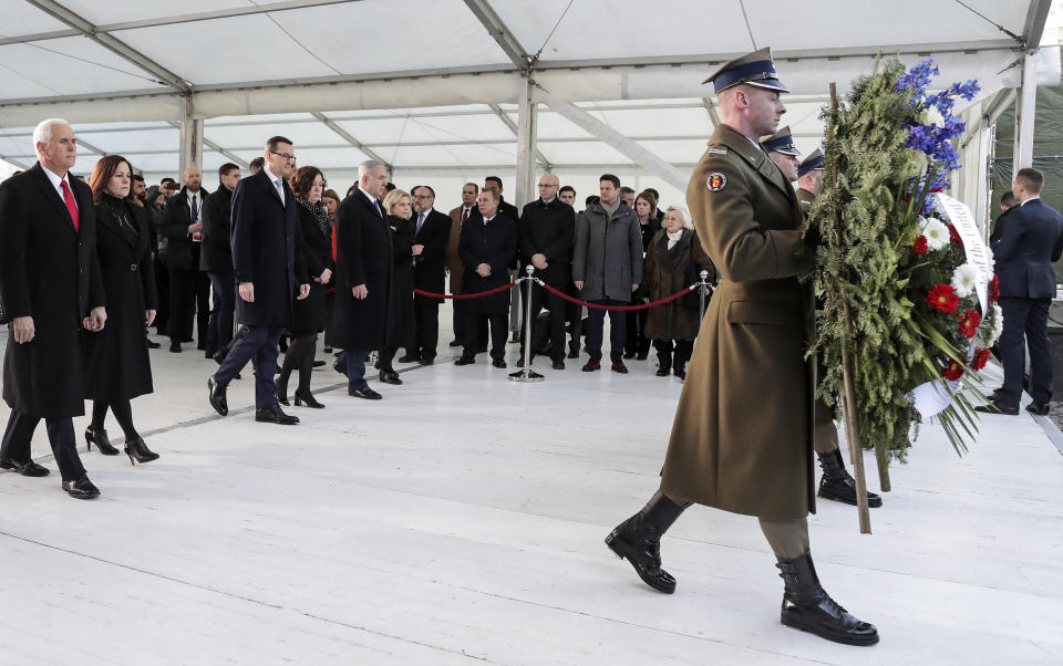 United States Vice President Mike Pence with his wife Karen, Prime Minister of Poland Mateusz Morawiecki with his wife Iwona and Israeli Prime Minister Benjamin Netanyahu with his wife Sara, from left, walk to a wreath laying ceremony at the Monument to the Ghetto Heroes in Warsaw, Poland, Thursday, Feb. 14, 2019. The Polish capital is host for a two-day international conference on the Middle East, co-organized by Poland and the United States. (AP Photo/Michael Sohn)