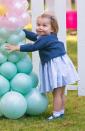 <p>Charlotte is overjoyed at the sight of balloons during an official tour of Canada with her parents and big brother in September 2016. </p>