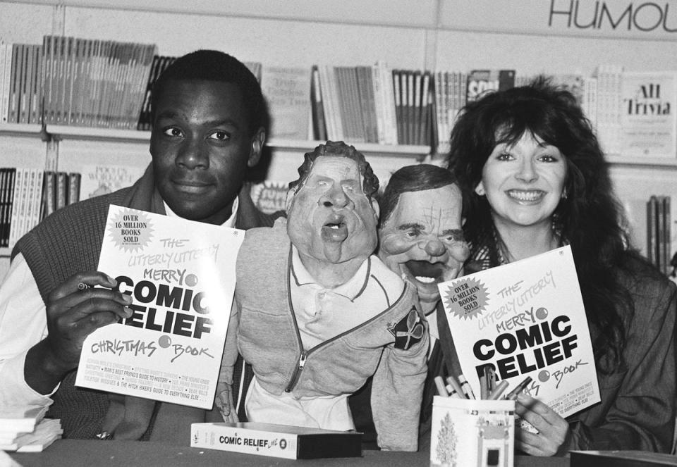 Spitting Image puppets of John McEnroe and Jefferey Archer flanked by Lenny Henry and Kate Bush at the launch of the Comic Relief book in 1986 (PA )